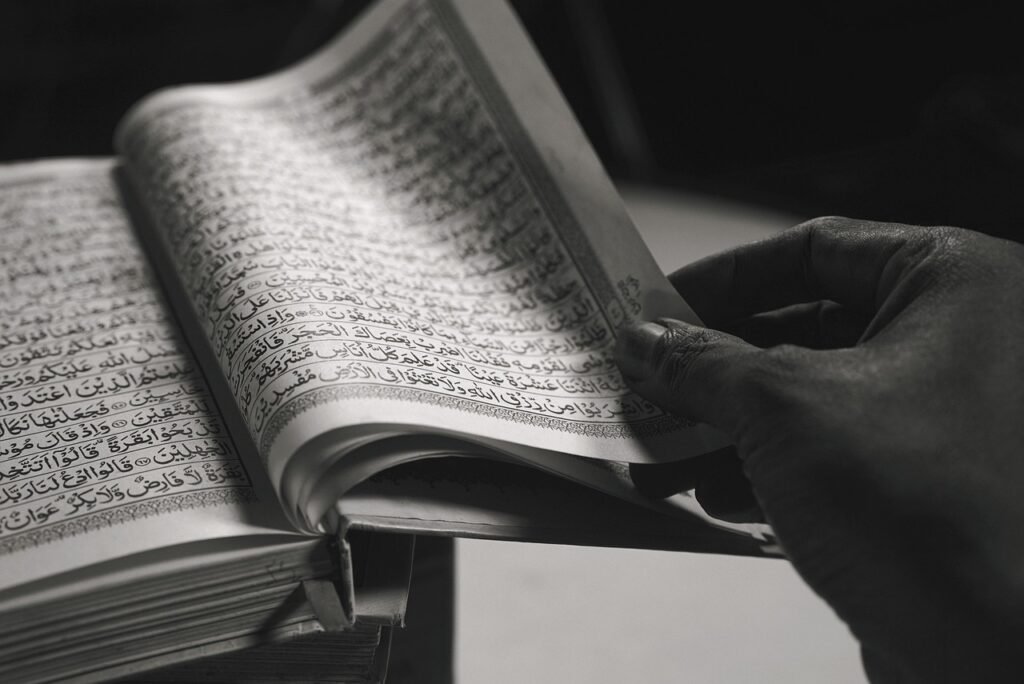 Muslim adult attending an online Quran lesson with a teacher
